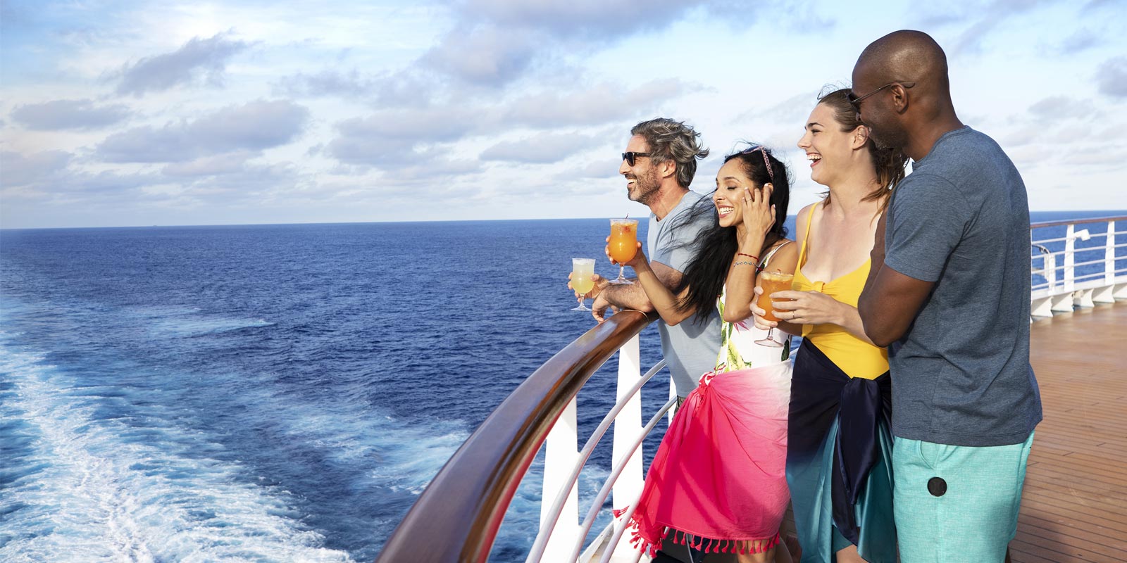 Group of people celebrating on a boat on the water.